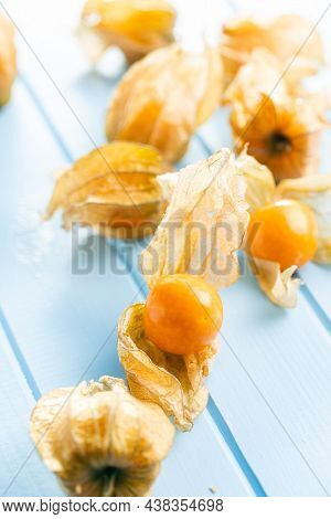 Physalis peruviana. Cape Gooseberry or ground cherries fruit on blue table.