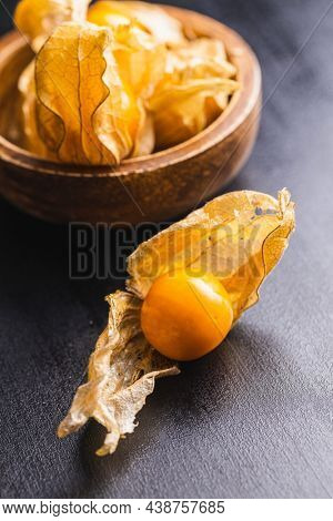 Physalis peruviana. Cape Gooseberry or ground cherries fruit on black table.