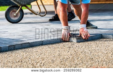 Laying Gray Concrete Paving Slabs In House Courtyard Driveway Patio.