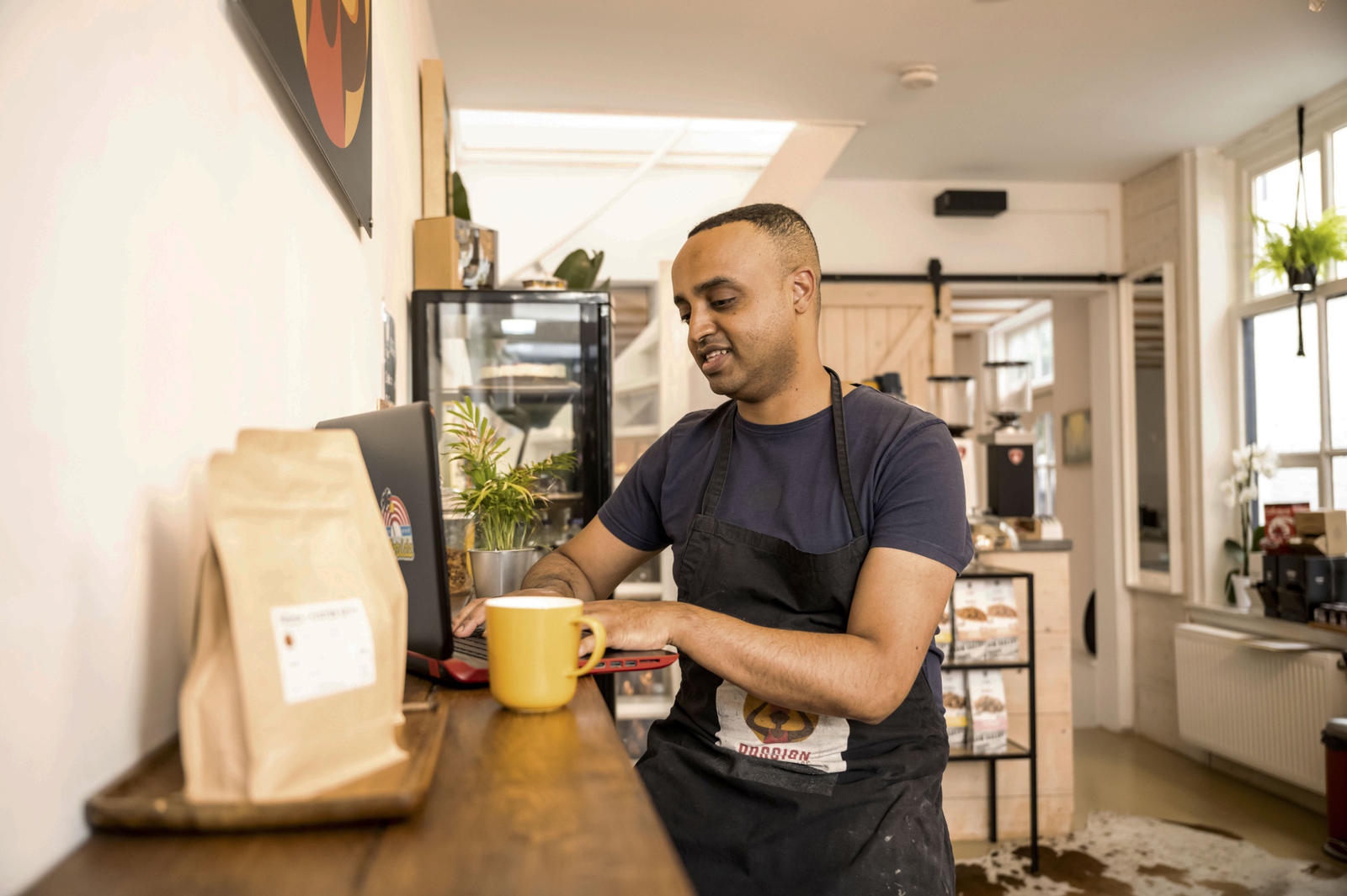 Man at coffee shop on laptop