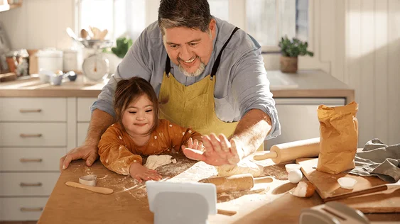 picture of a parent and child baking in a kitchen