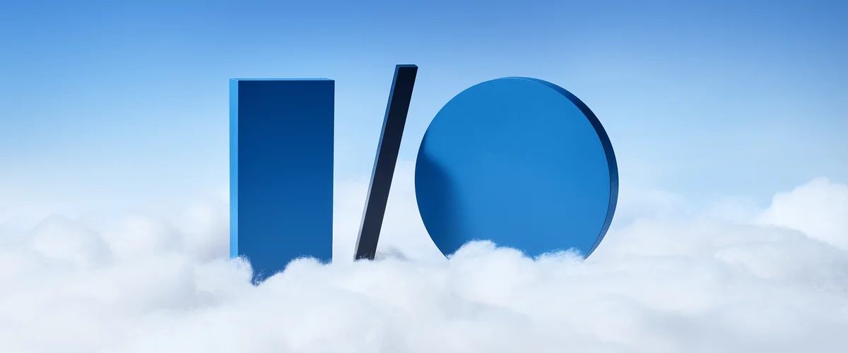 An illustration of a giant blue “I slash O” floating on top of clouds against a blue sky background.