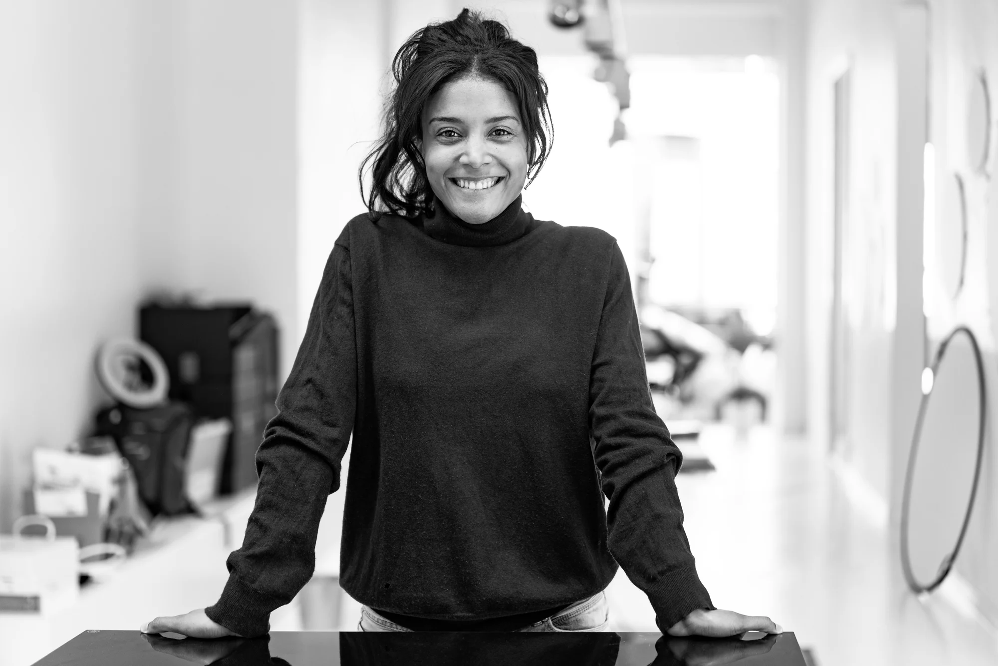 Image showing a black and white photo of Nancy de Fays looking into the camera and smiling.