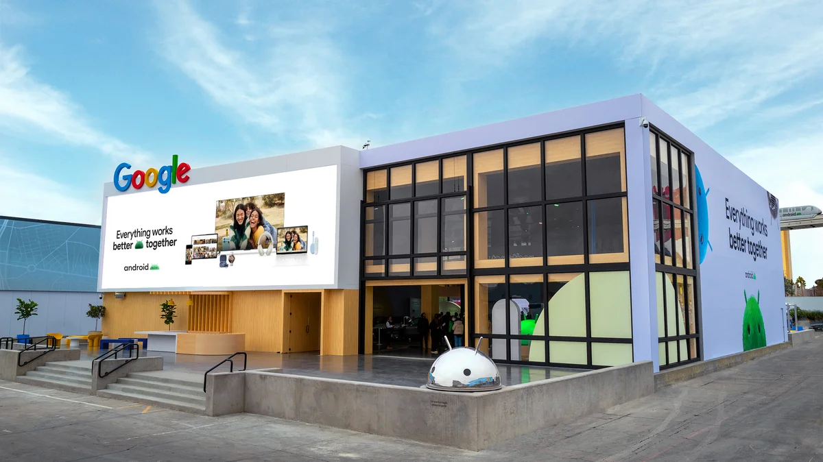 A photo of the Google booth at CES showcases a large white building with the Google and Android logo.