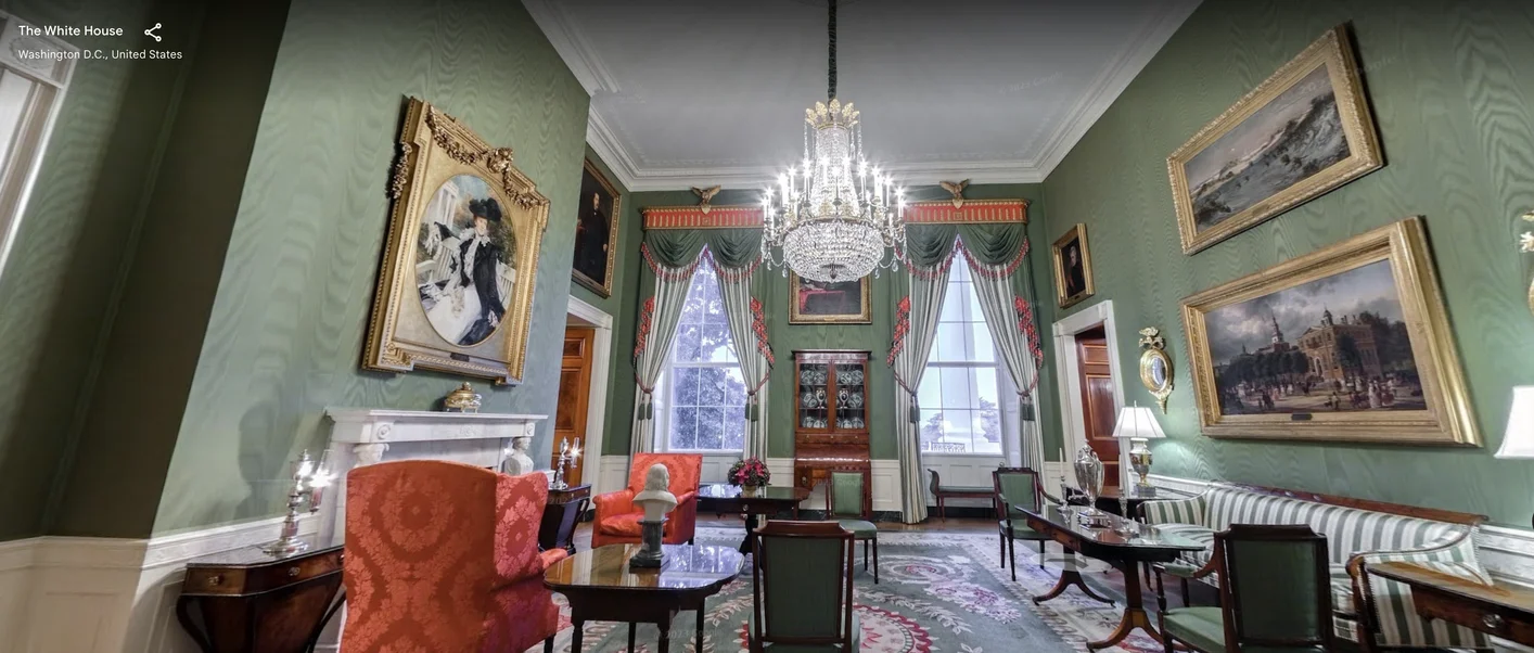The green room in the white house, the walls are green with paintings on them and a chandelier hangs from the middle of the room. Period piece furniture is throughout.