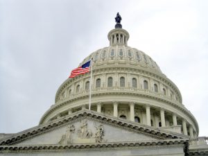 View of the Capitol Building Dome with the United States flag. Washington D.C. USA travel