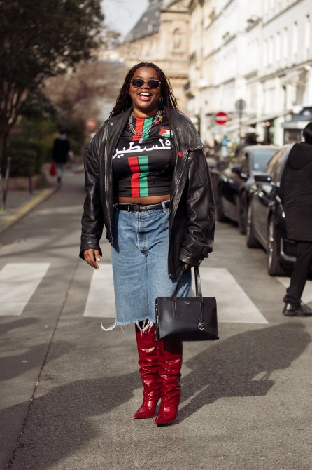 Gabriella Karefa-Johnson wears dark deep red boots, blue denim shorts Bermuda, a Palestine jersey, black leather jacket and sunglasses outside The Row during the Womenswear Fall/Winter 2024/2025 as part of  Paris Fashion Week on February 28, 2024 in Paris, France.