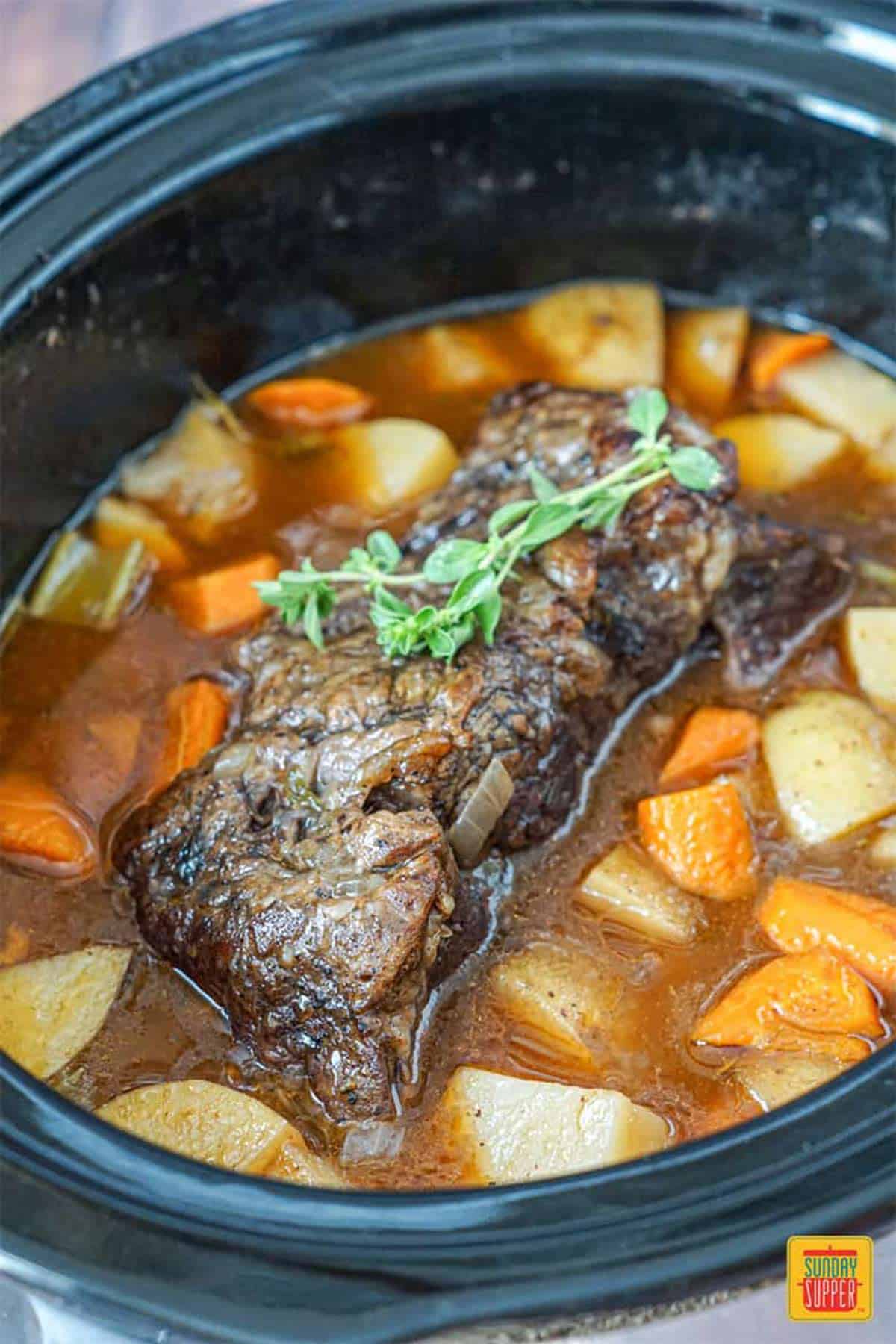 Slow cooker chuck roast in the slow cooker after cooking