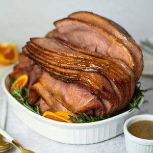 honey glazed ham in a white dish