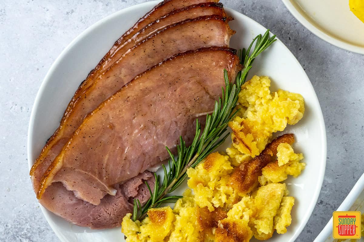 slices of honey glazed ham on a white plate