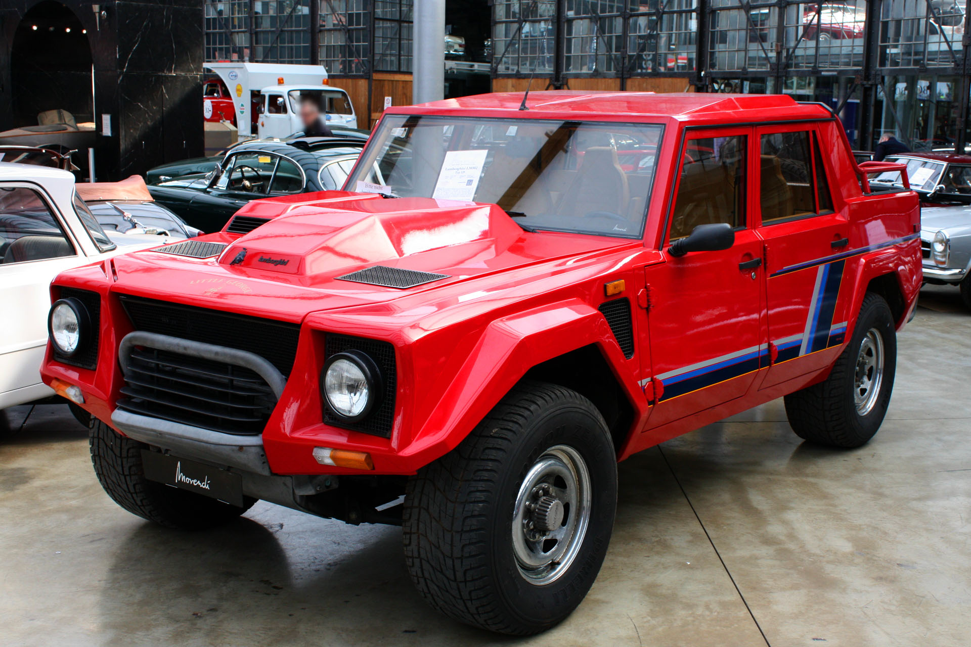 Lamborhini LM002 in red in a showroom.