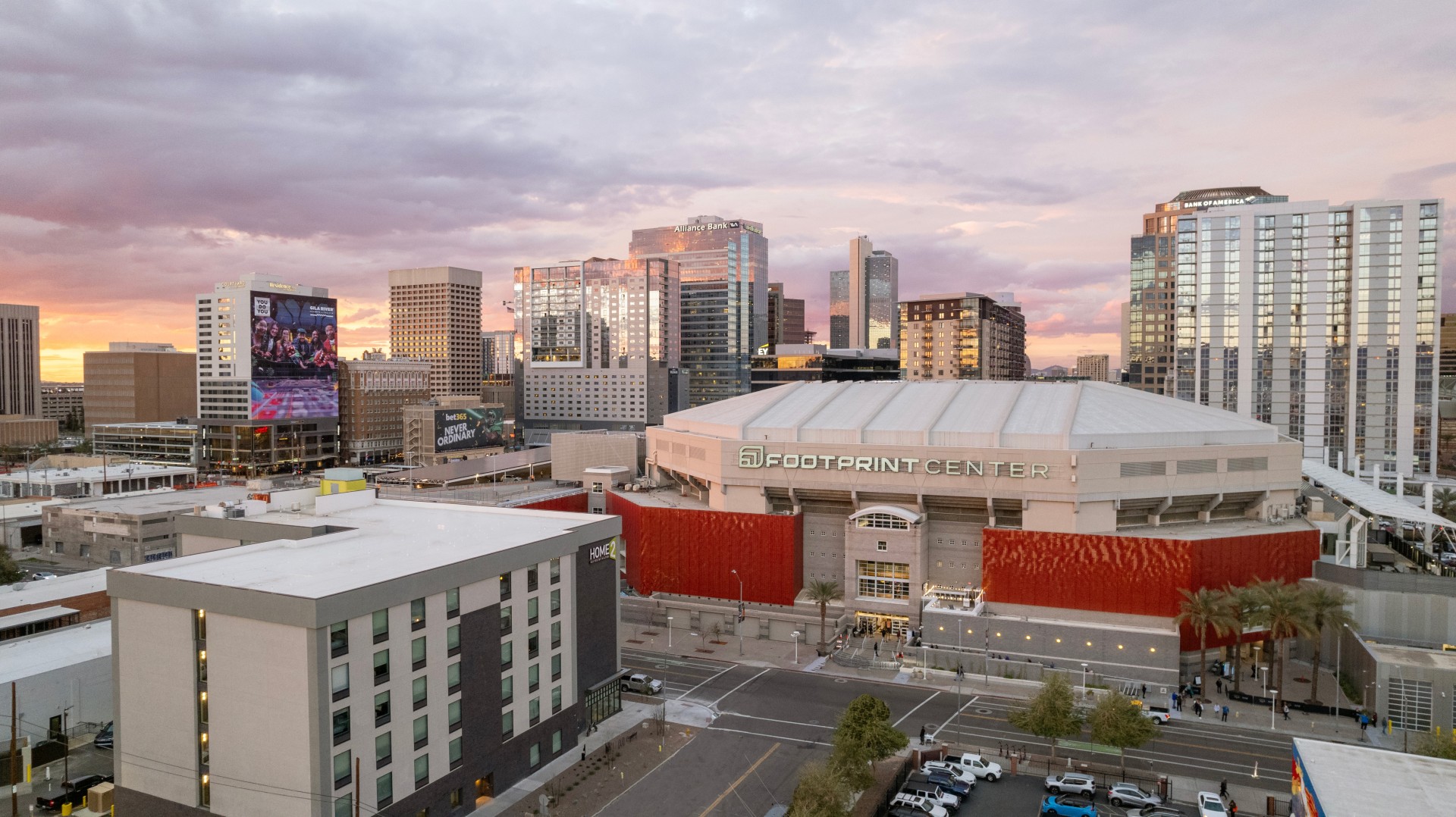 a large city with a large building and a parking lot