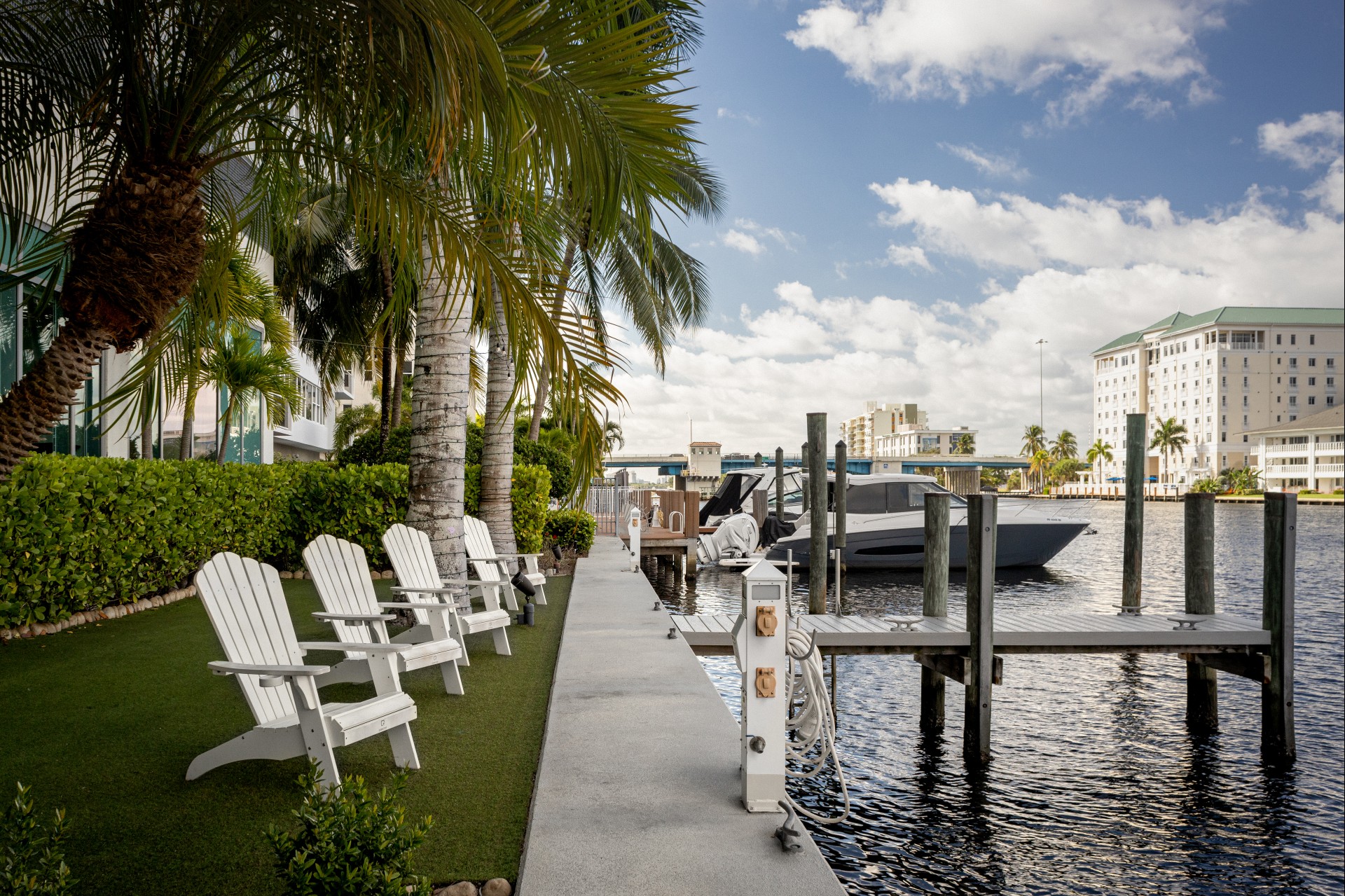 a row of white chairs next to a dock