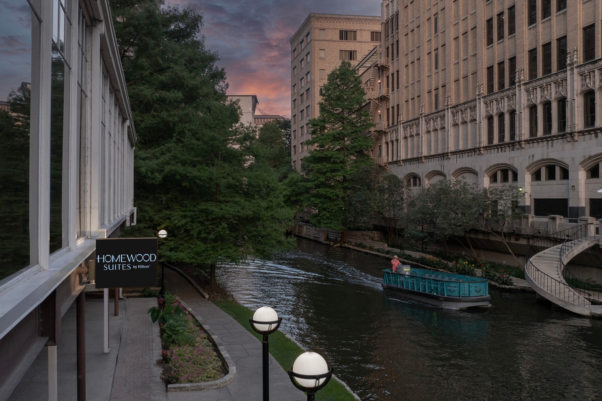 a boat on a river with buildings in the background