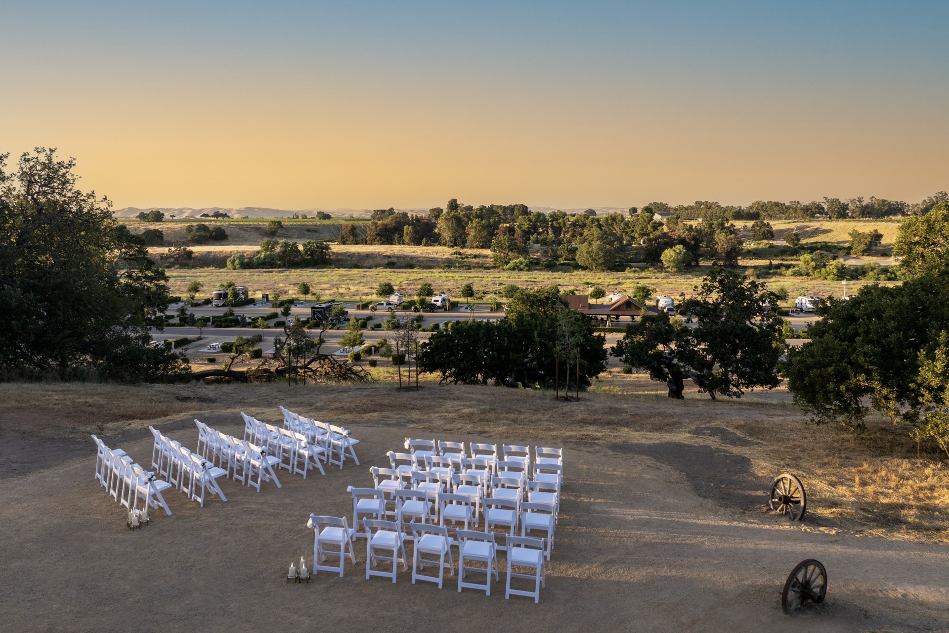 a group of chairs and a wagon in a field