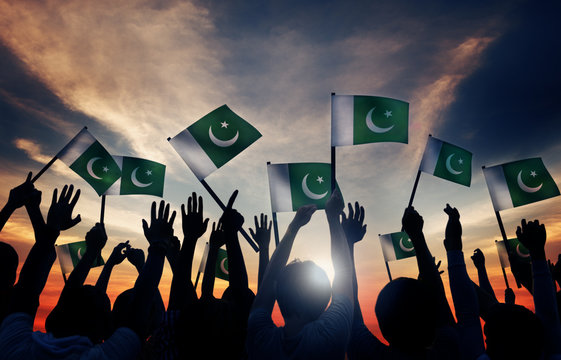 Group of People Waving Flag of Pakistan in Back Lit