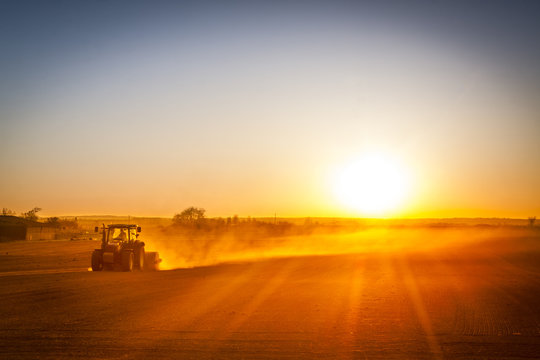 Farmer preparing his field in a tractor ready for spring