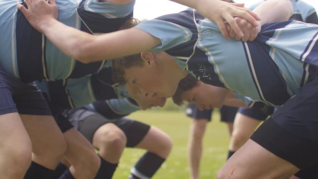  Young team players in a scrum at rugby match