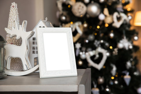 Empty photo frame in christmas interior background, blank mockup template