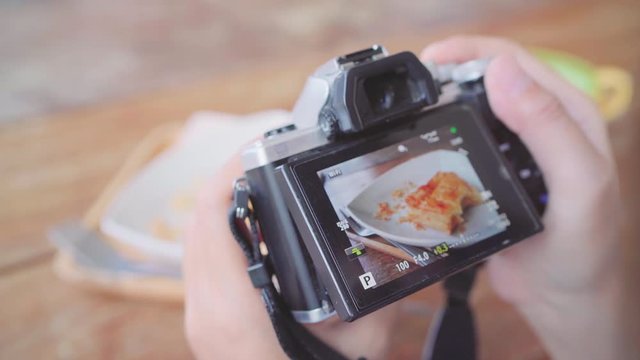 Food blogger Asian woman using camera for photo dessert, bread and drink while sitting on table in cafe. Lifestyle beautiful women relax at coffee shop concepts.