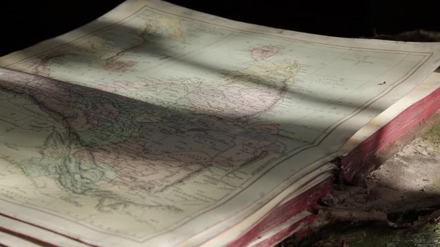 Old Damaged Map Book Open Outside On Rotton Wooden Sill