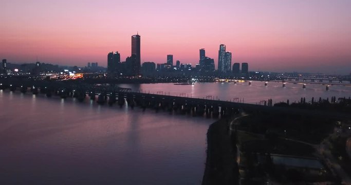 Drone Aerial footage  moving backwards from buildings in Seoul, South Korea - Sunset