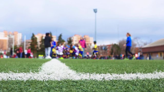 unrecognizable children's rugby tournament, unfocused view