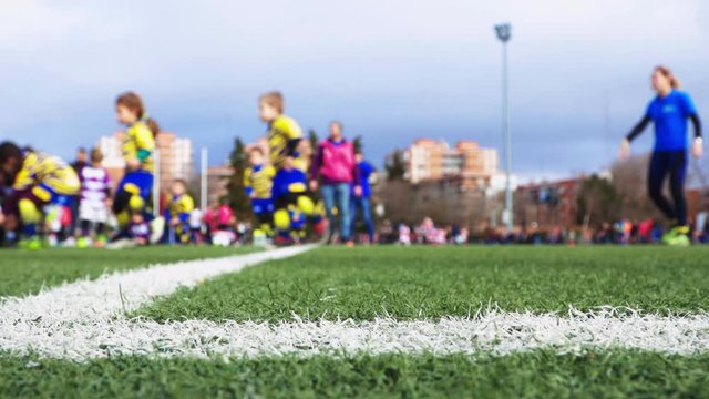 unrecognizable children's rugby tournament, unfocused view