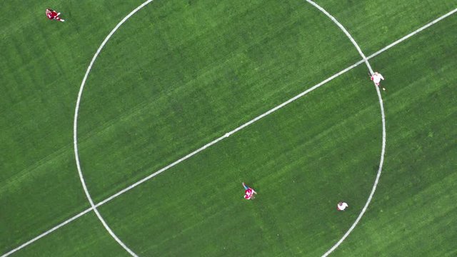 Aerial Top Down View of Soccer Field. Beginning of game. Two teams playing ball in football outdoors. Head over shot.