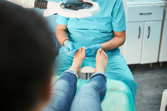 Patient visiting chiropodist podiatrist in beauty center