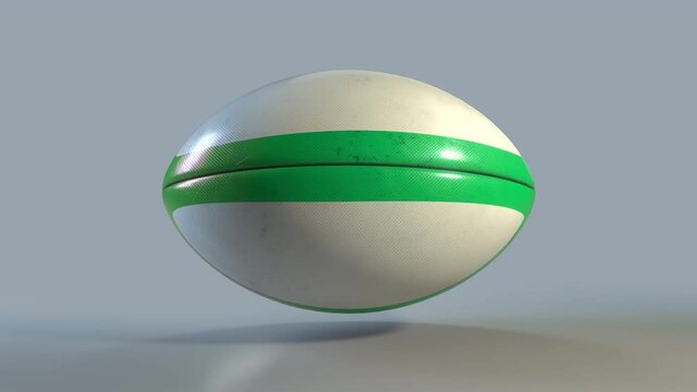 Realistic 3D ruby ball with green lines in a constant spin. Standard rugby ball in a perfect loop. Animated footage with a luma matte for isolating the ball.