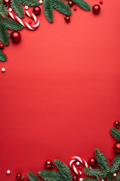 Red Christmas background with fir branches and decorations