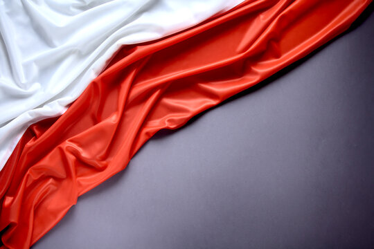 Polish flag on a gray background, copy space. Independence Day November 11, Poland.