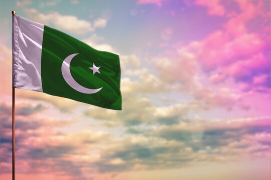 Fluttering Pakistan flag mockup with the space for your content on colorful cloudy sky background.