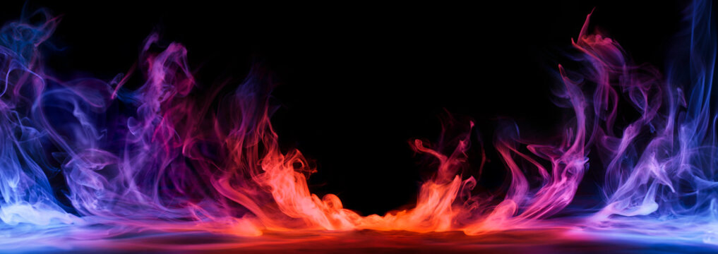 Dramatic smoke and fog in contrasting vivid red, blue, and purple colors. Vivid and intense abstract background or wallpaper.