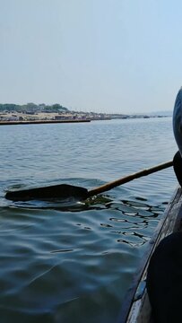 Vertical footage of boating in Yamuna river with view of New Yamuna bridge