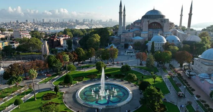 Istanbul, Turkey. Sultanahmet with the Blue Mosque and the Hagia Sophia with a Golden Horn on the background at sunrise. Cinematic Aerial view.