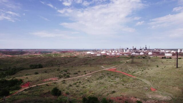 Drone footage of Oil Refinery landscape with blue cloudy sky in Borger city, Texas