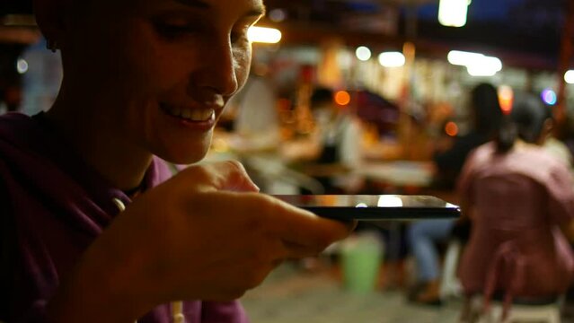 Woman with short hair photographing salad in her plate, street food Thailand Generative AI