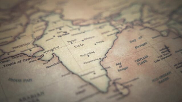 India on a vintage political world map. Slow motion, tracking arc shot. 