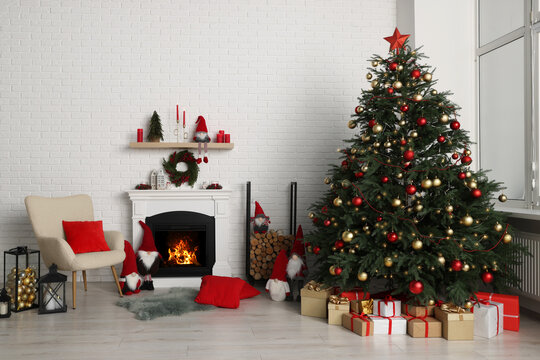 Beautiful Christmas themed photo zone with tree and fireplace in room