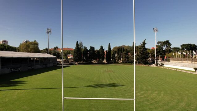 Aerial drone through goal posts on rugby pitch, rugby field