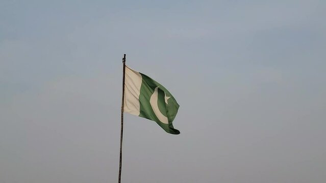 Flag on the wind, Waving Pakistani flag isolated on blue sky