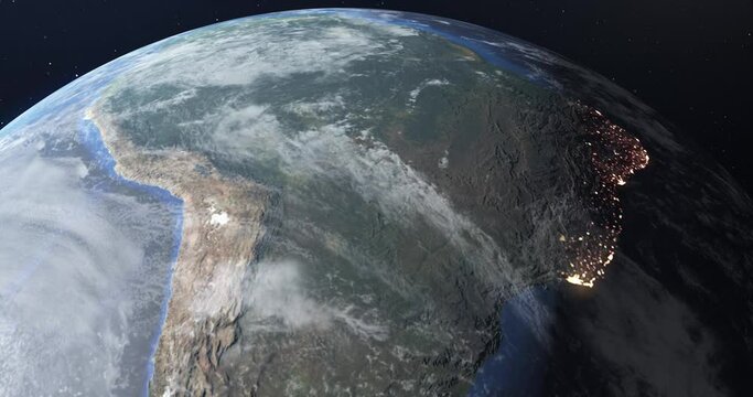 Flight in low Earth orbit at twilight, view from space. The lights of South American cities glow at night to show the concentration and density of population. 3D animation. Contains NASA images.