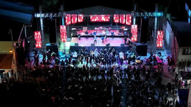 Drone footage of a musical festival in the Main Square of Gomez Farias Municipality at night, Mexico