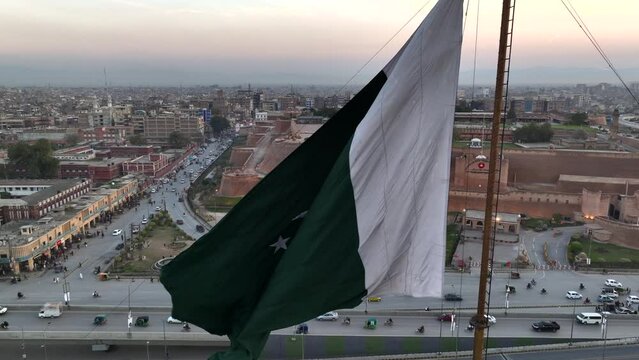 Big Flag of Pakistan in Peshawar in slow motion at sunset time, evening. Bala Hisar Fort Peshawar Pakistan, Drone Aerial