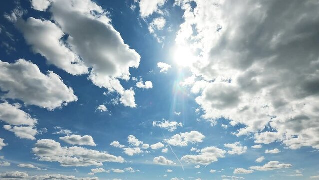 beautiful fluffy white cumulus clouds in blue sky summer season. dramatic cloud covered bright sun star in clear good atmosphere day, cloudscape timelapse of power sun beams, rays in midday, blue sky 