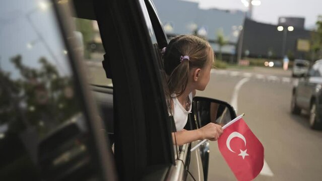 Kid traveling in Turkey while holding flag. Slow motion