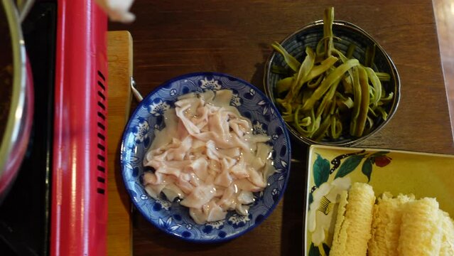 sichuan red spicy hot pot chopsticks eating duck organ intestine and Chinese mala soup top view