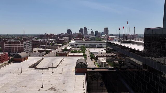 Aerial drone footage of downtown St. Louis, MO on a clear blue sky summer day looking at skyscraper buildings.